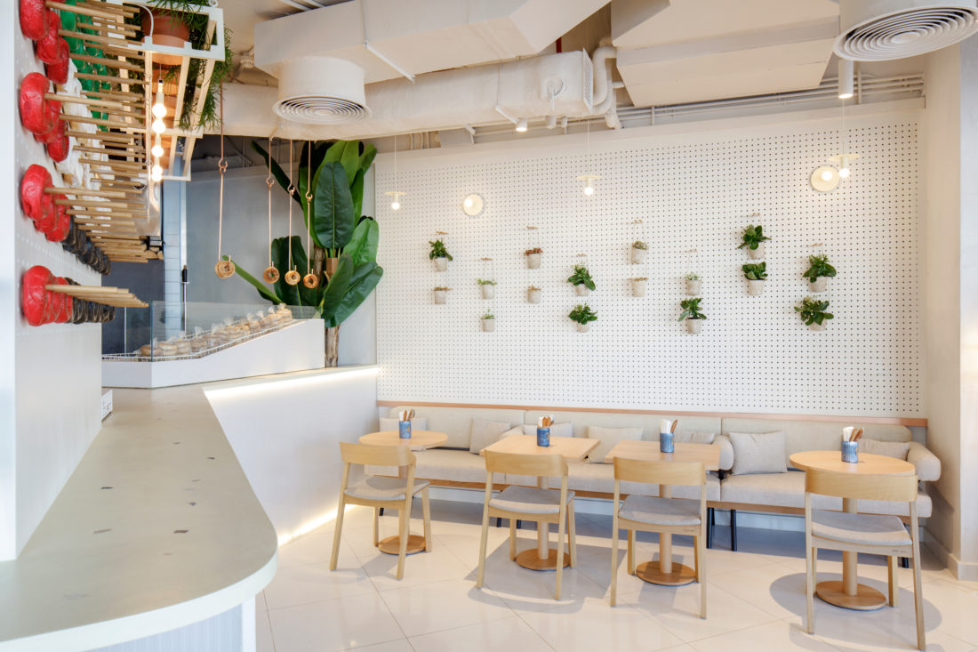 H2R Design uses greenery and wooden textures for the Bagel Yard project ...